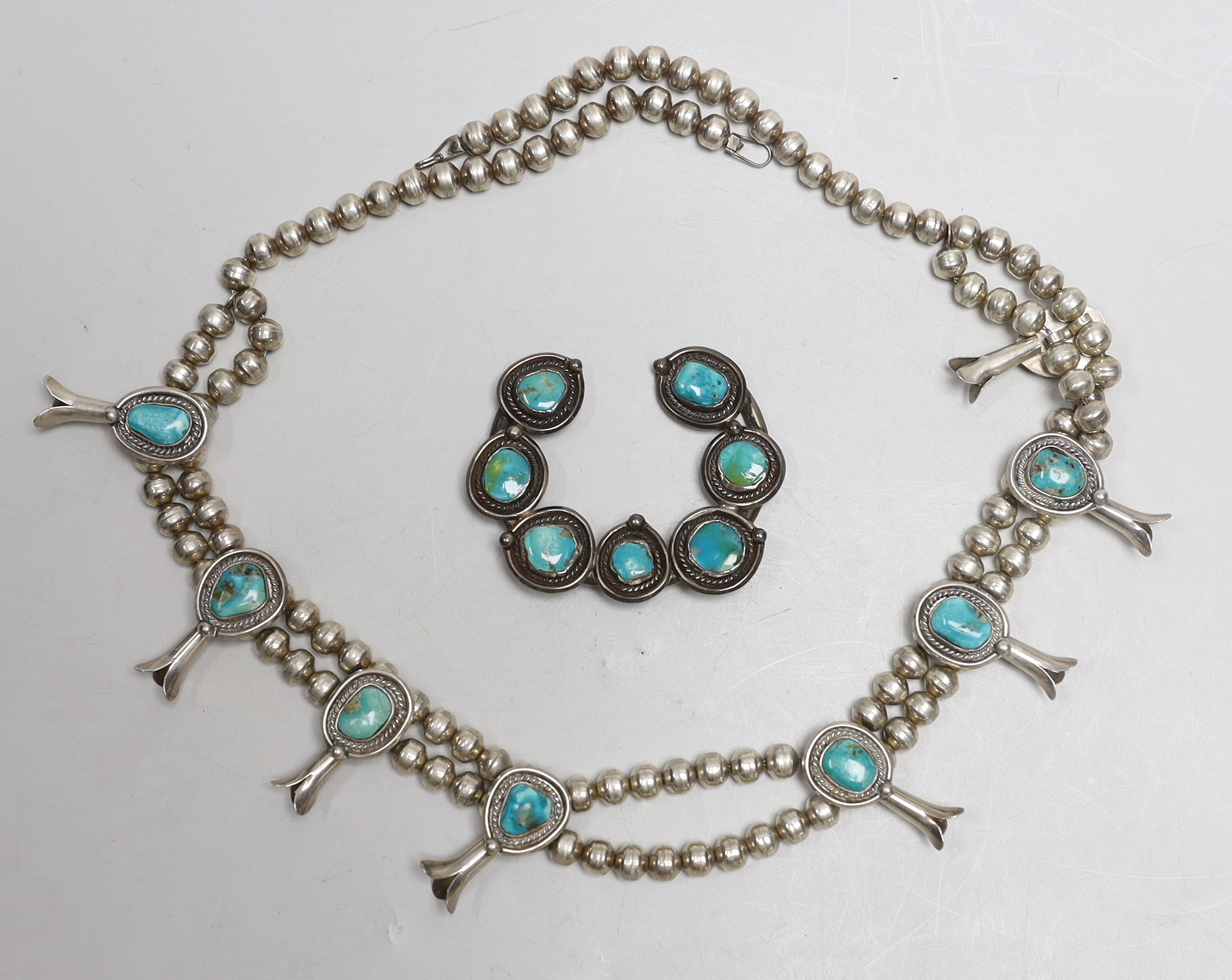 A South American? white metal and turquoise set necklace, 66cm and a similar brooch.